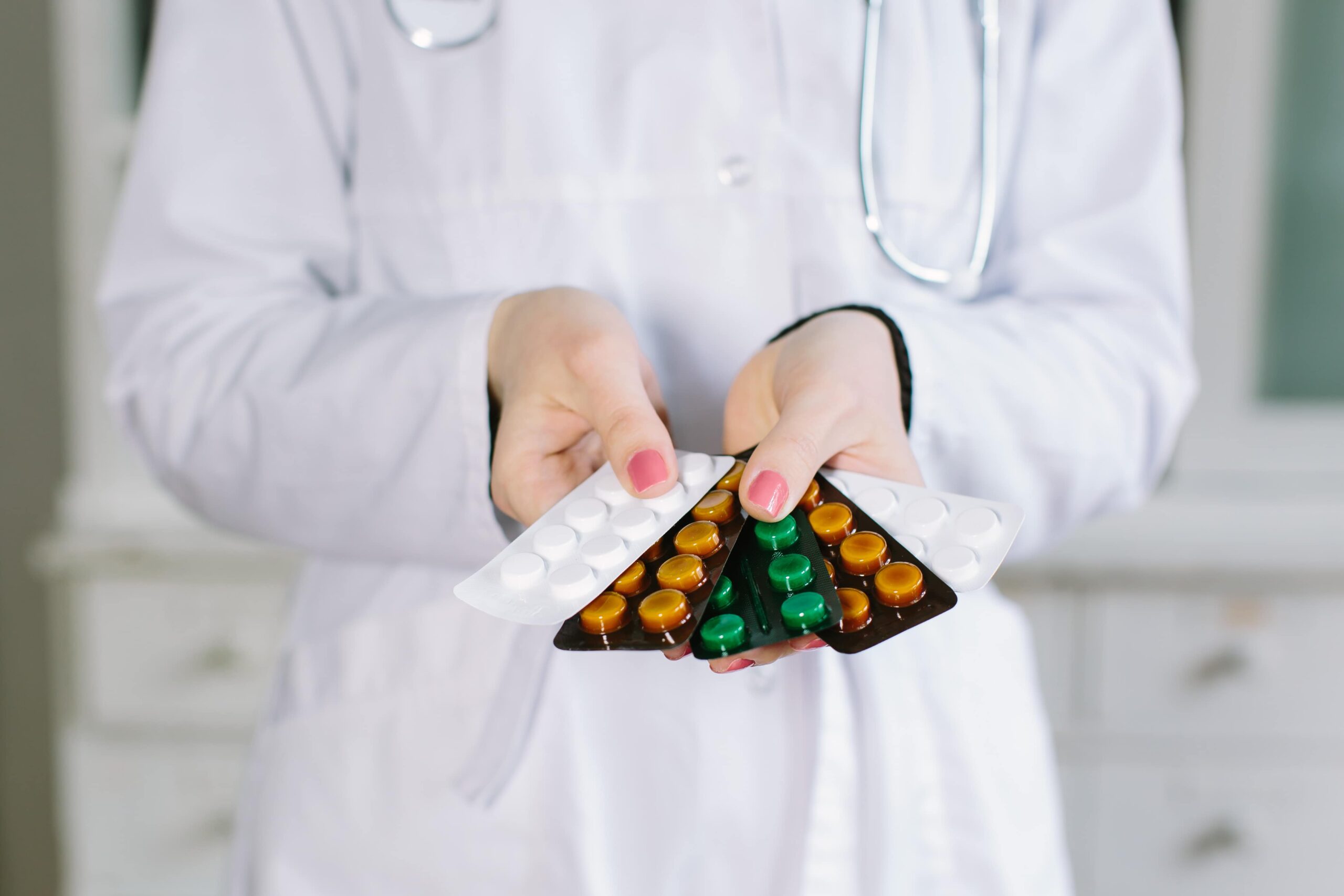 Pharmacist holding blister packs of medicine